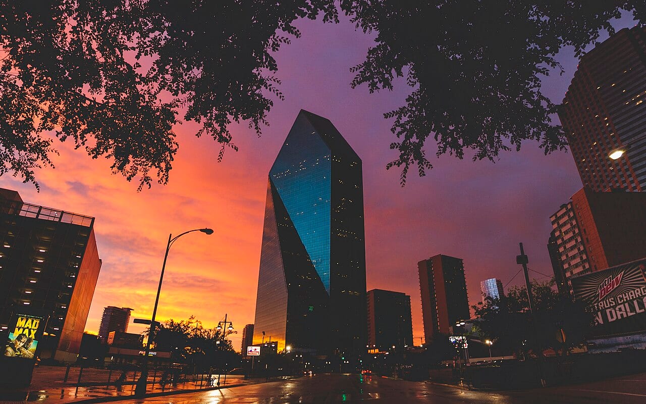 Fountain Place in Dallas beneath a dramatic sunset.